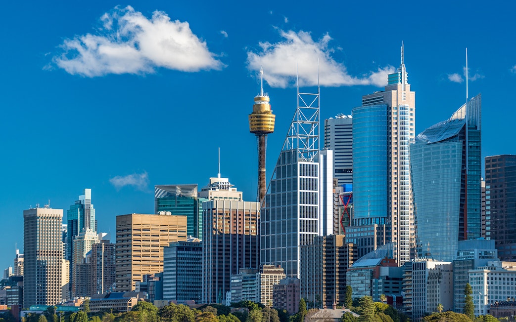 Sydney skyline featuring the Sydney Tower and modern skyscrapers.