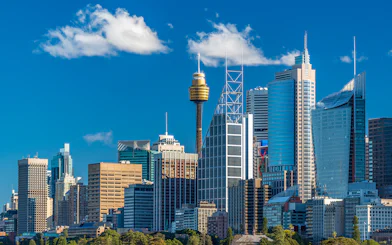 Sydney skyline featuring the Sydney Tower and modern skyscrapers.