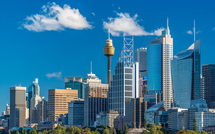 Sydney skyline featuring the Sydney Tower and modern skyscrapers.