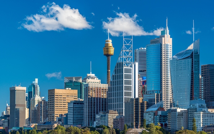 Sydney skyline featuring the Sydney Tower and modern skyscrapers.