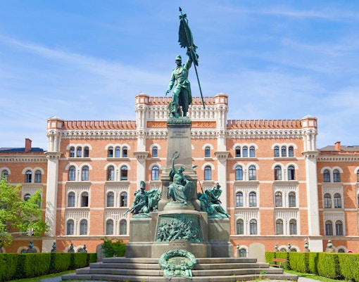Rossauer Barracks in Vienna with a prominent statue in the foreground.