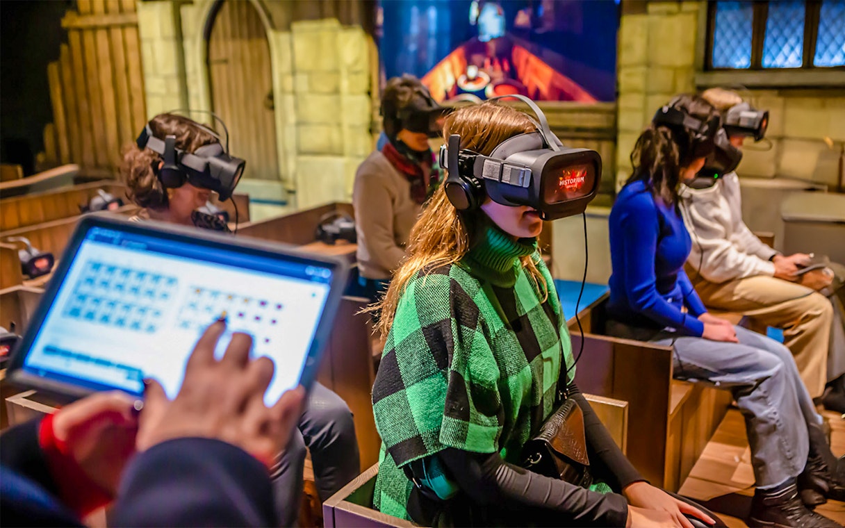 Visitors using VR headsets at Historium Bruges experience.