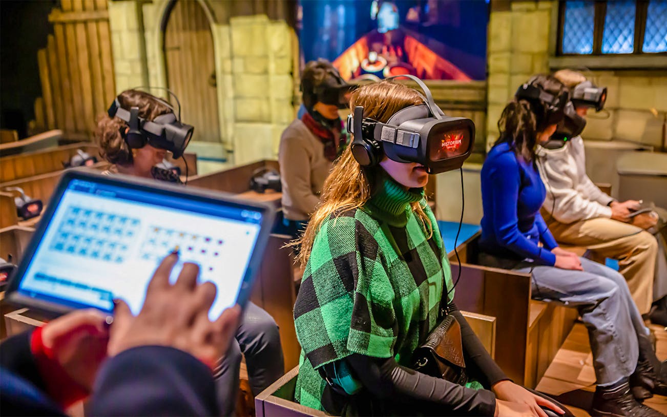 Visitors using VR headsets at Historium Bruges experience.