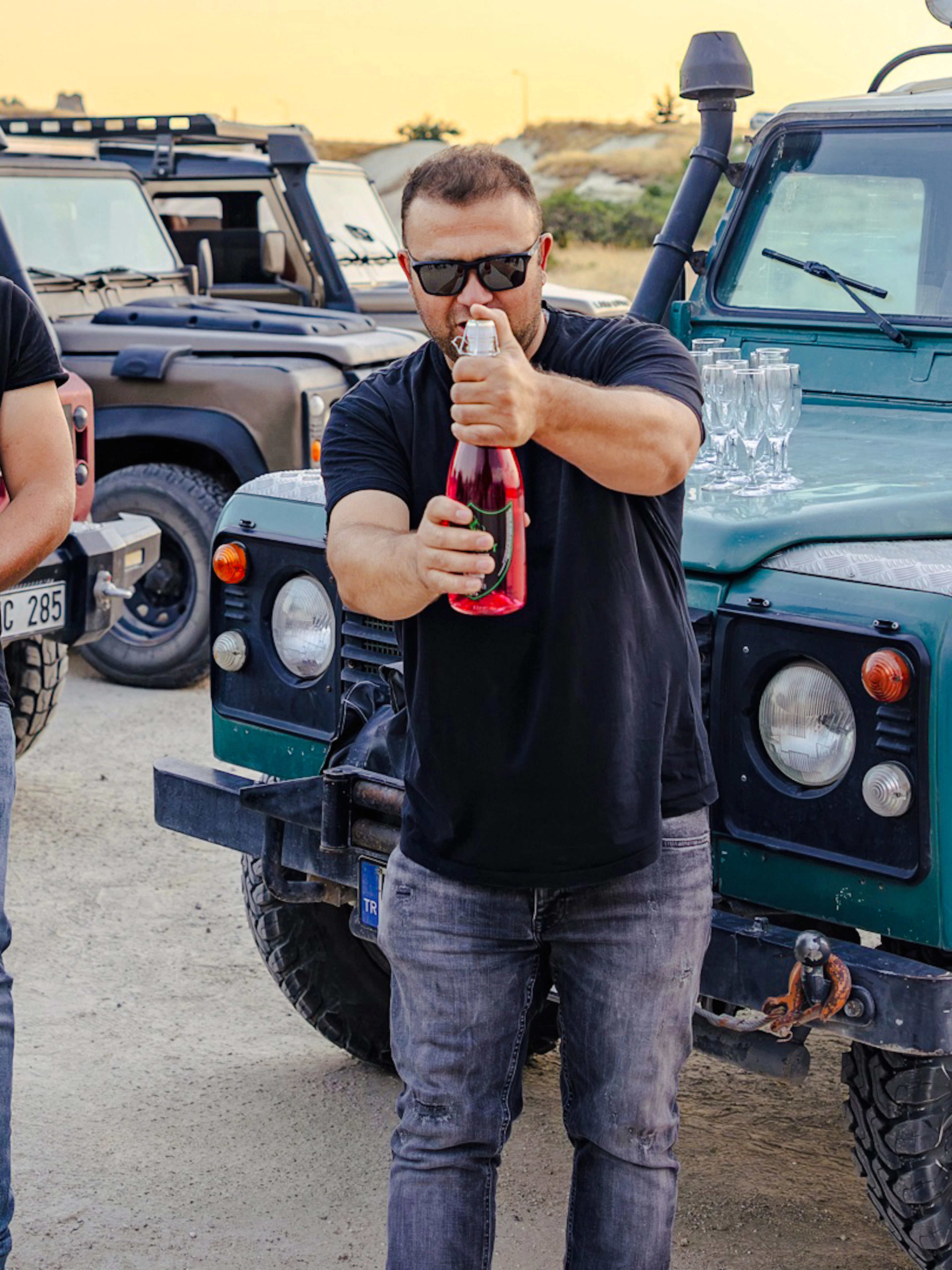 Men preparing drinks beside jeeps during Cappadocia Private Jeep Safari.