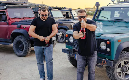 Men preparing drinks beside jeeps during Cappadocia Private Jeep Safari.