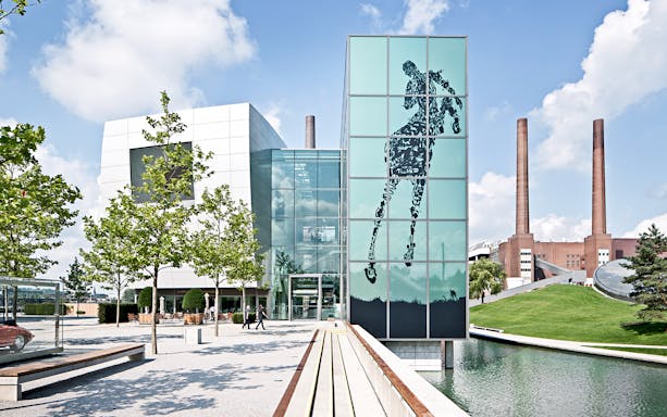 Wolfsburg Autostadt Theme Park entrance with modern architecture and outdoor art installation.
