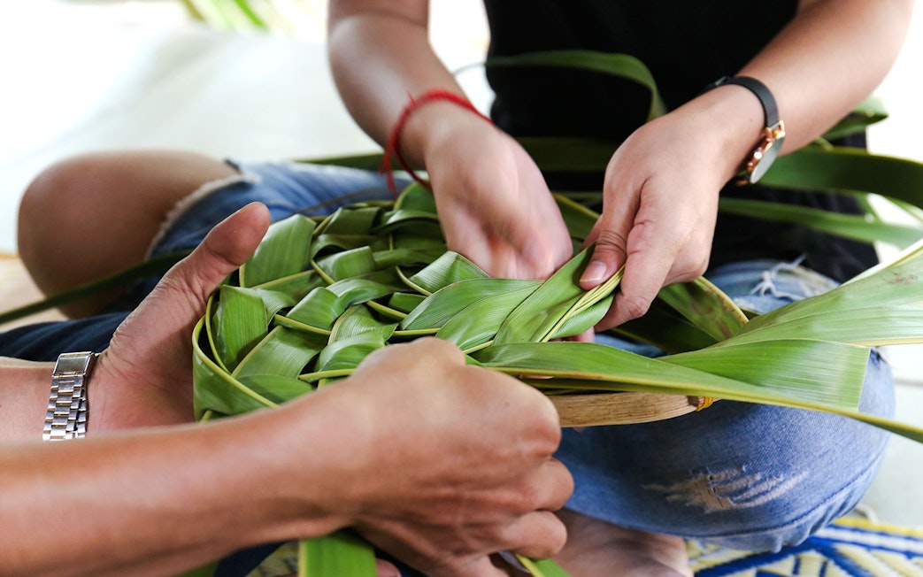 Coconut leaf basket weaving at a workshop.