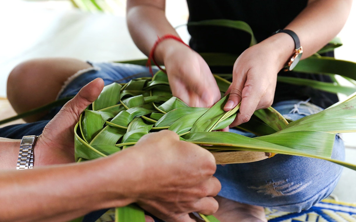 Coconut leaf basket weaving at a workshop.