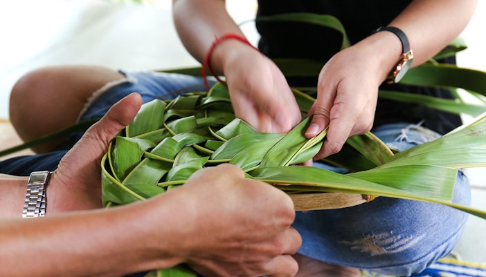 Coconut leaf basket weaving at a workshop.