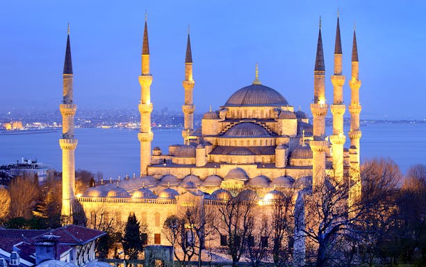 Blue Mosque in Istanbul at dusk, highlighting minarets and domes, related to kebab and dervish experiences.