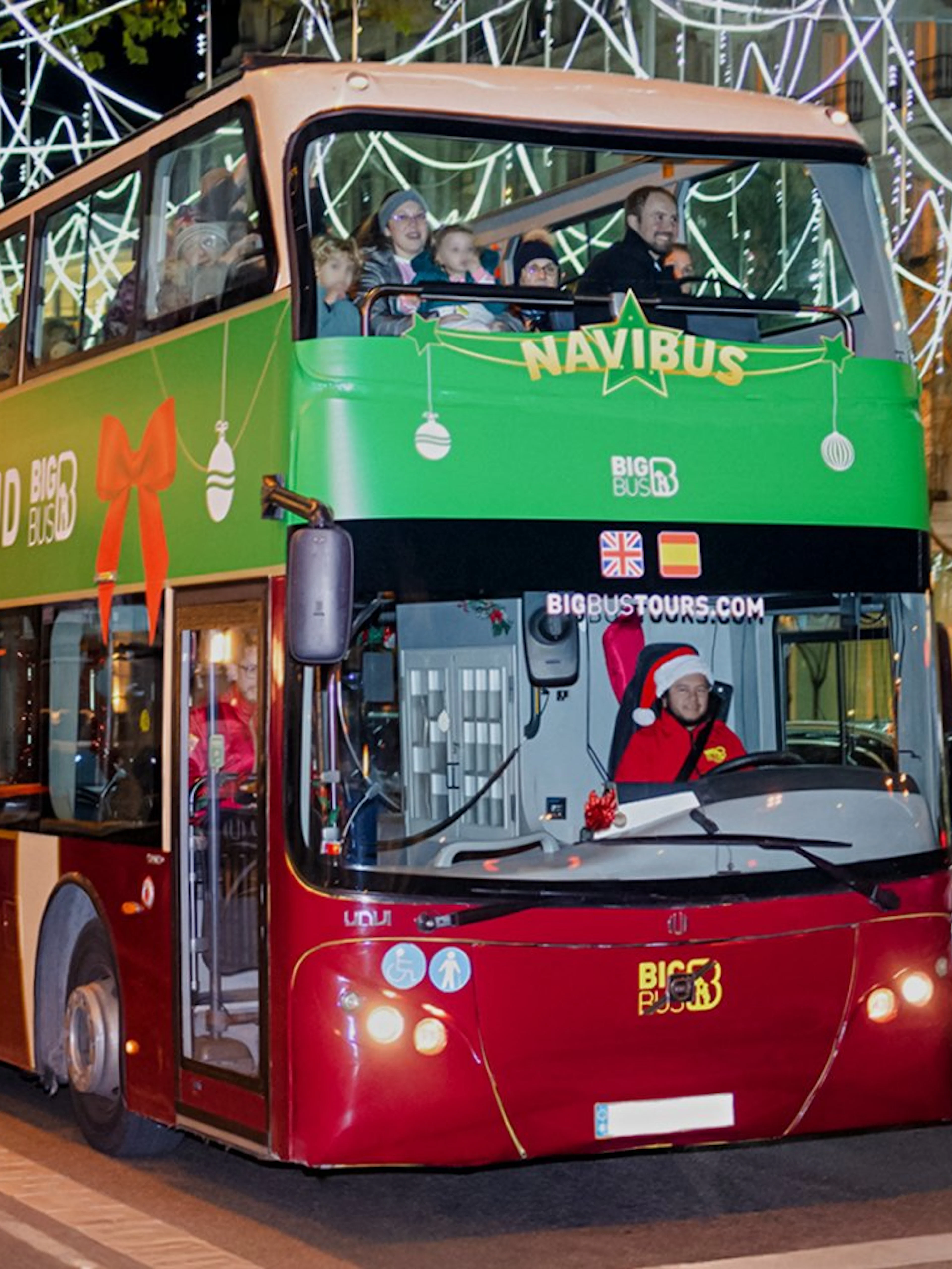 Double-decker bus on Madrid Navibus Christmas Tour with festive lights.