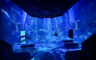 Immersive digital art installation at ARTECHOUSE DC with vibrant blue ocean theme.