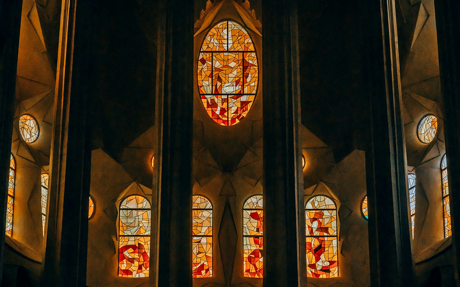 Stained glass windows inside Sagrada Familia, Barcelona, showcasing vibrant colors and intricate designs.