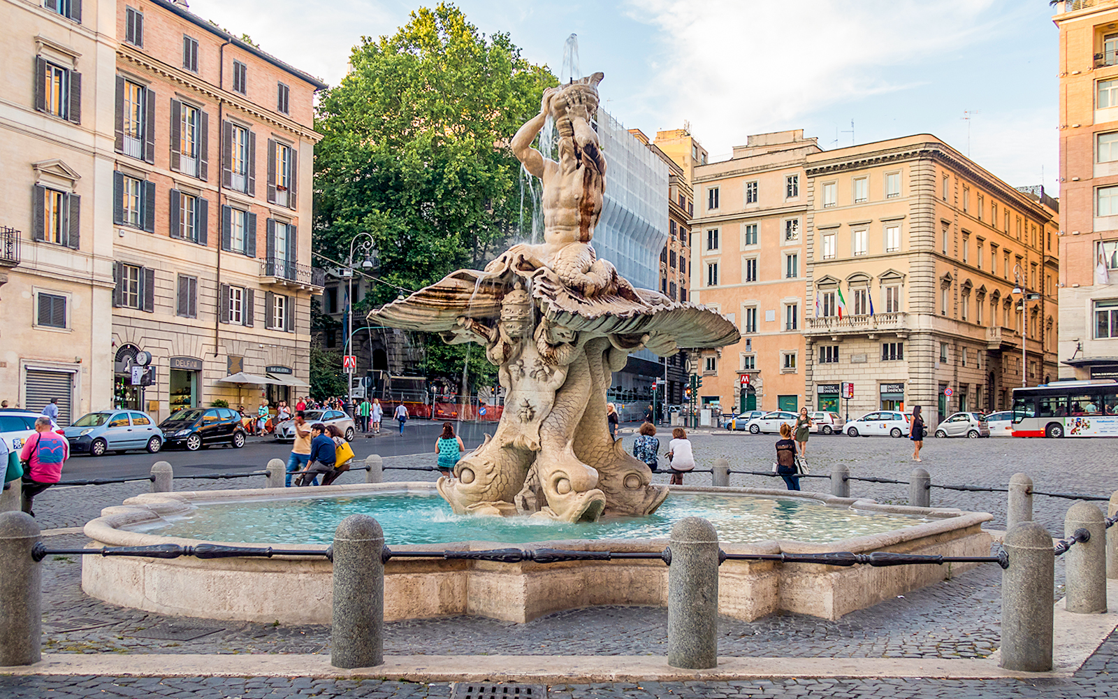 Fountain of Triton in Piazza Barberini, Rome, surrounded by historic buildings.