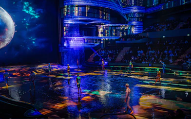 Performers on illuminated stage at La Perle show in Dubai.