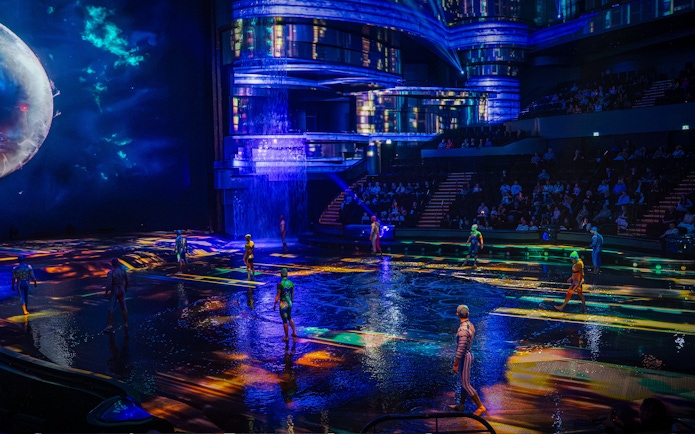 Performers on illuminated stage at La Perle show in Dubai.