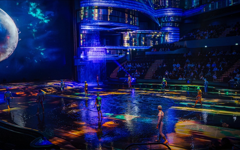 Performers on illuminated stage at La Perle show in Dubai.
