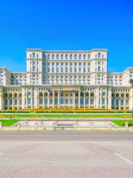 Palace of the Parliament in Bucharest, Romania, with clear blue sky.