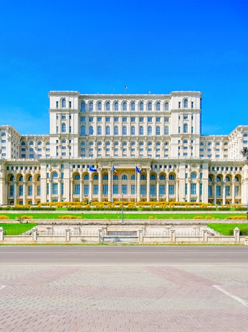 Palace of the Parliament in Bucharest, Romania, with clear blue sky.