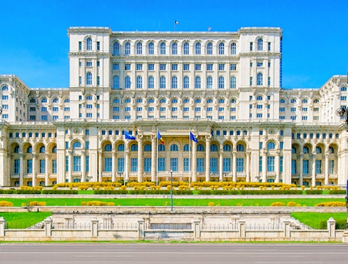 Palace of the Parliament in Bucharest, Romania, with clear blue sky.