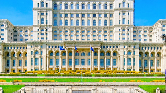 Palace of the Parliament in Bucharest, Romania, with clear blue sky.