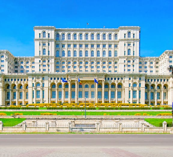 Palace of the Parliament in Bucharest, Romania, with clear blue sky.