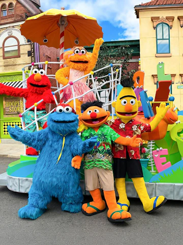 Sesame Street characters posing at Sesame Place San Diego parade.