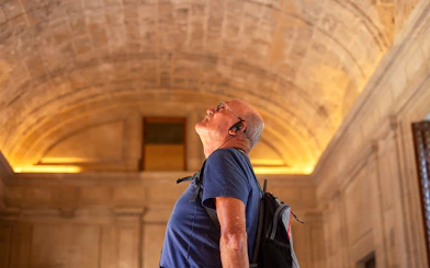 Man with audio guide admiring the Roman Pantheon interior.