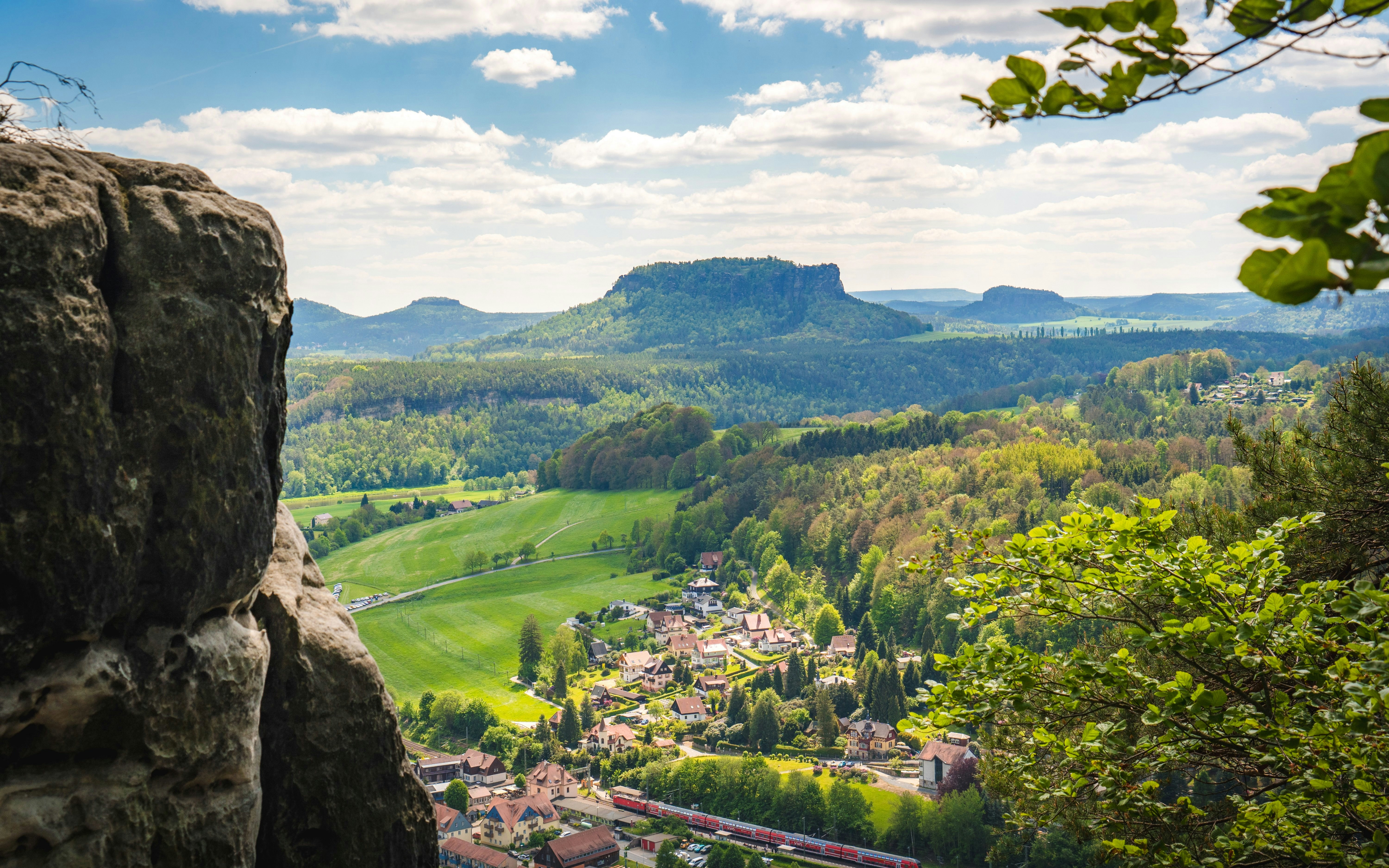 Saxon Switzerland landscape with mountains and a village in the valley.