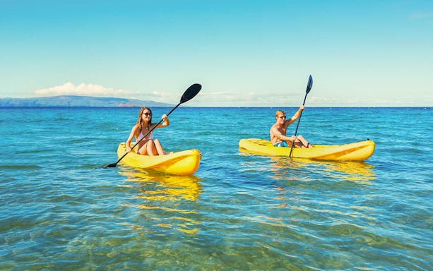 Couple kayaking on clear blue waters in Dubai.