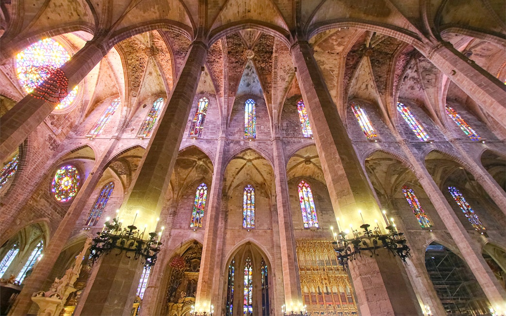 Cathedral of Majorca interior with stained glass windows and vaulted ceilings.