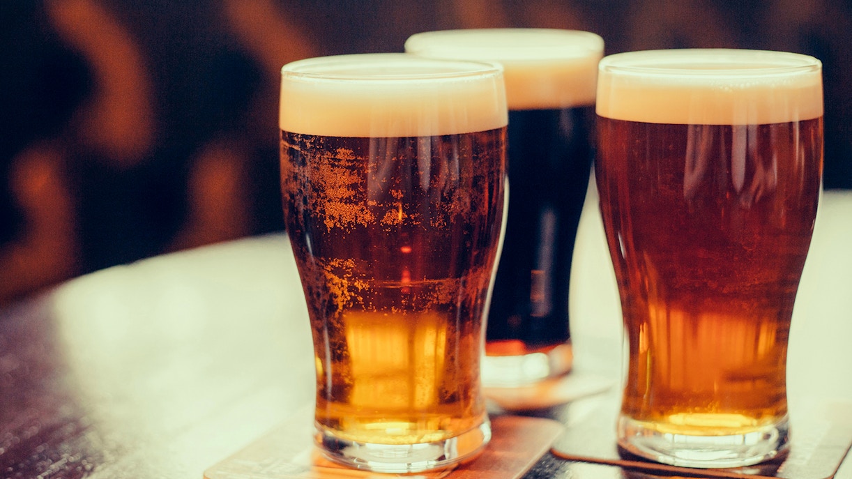 Three pints of beer on a table, part of a pirate ship tour experience.
