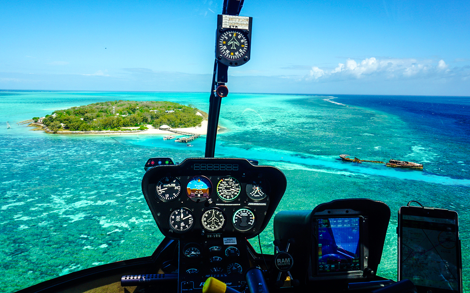 Helicopter cockpit view of Heron Island and Great Barrier Reef waters.