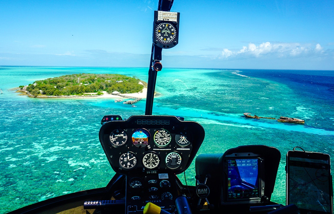 Helicopter cockpit view of Heron Island and Great Barrier Reef waters.