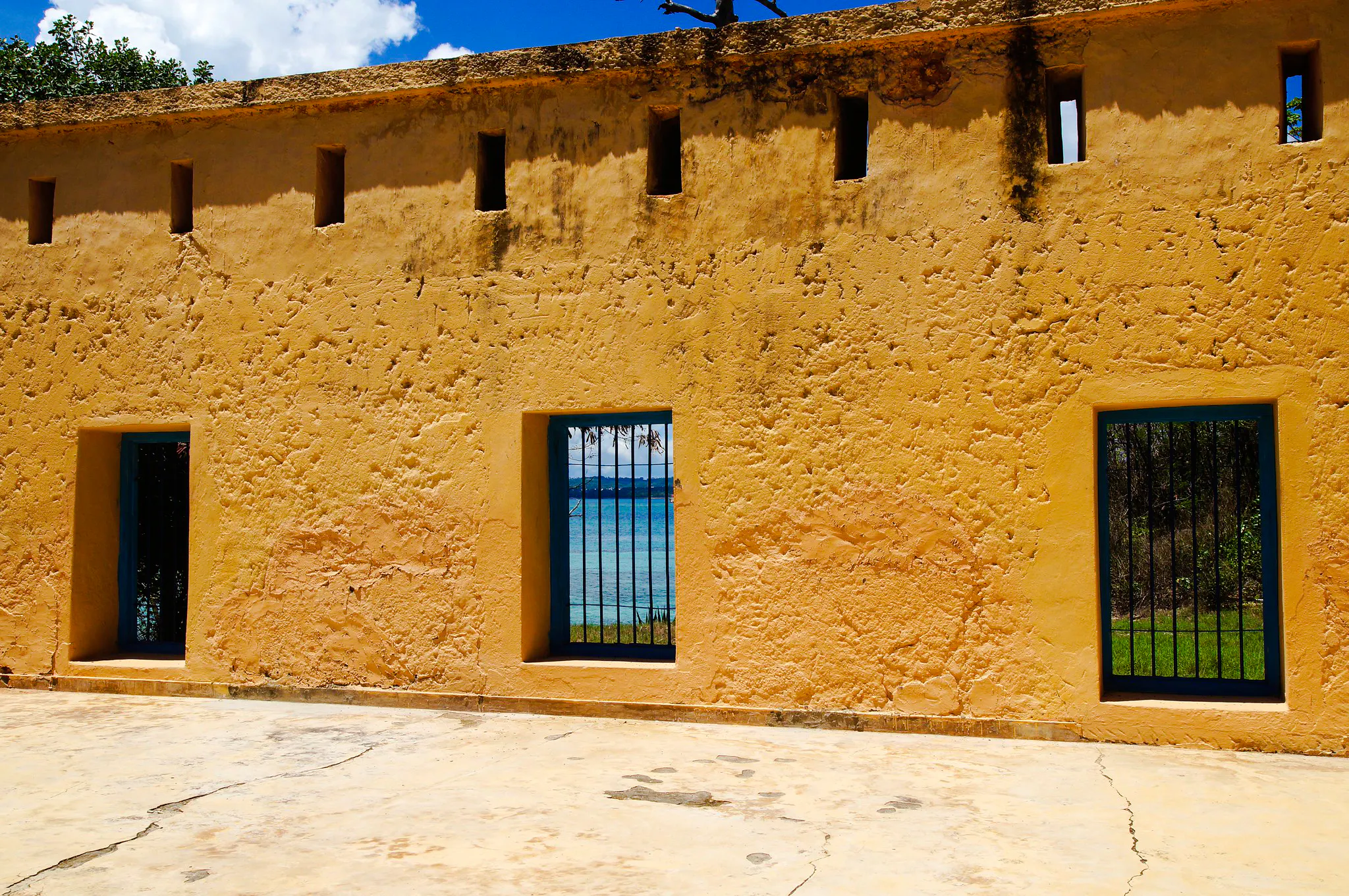 Prison Island building with barred windows overlooking the ocean in Zanzibar.