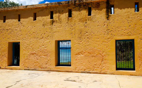 Prison Island building with barred windows overlooking the ocean in Zanzibar.