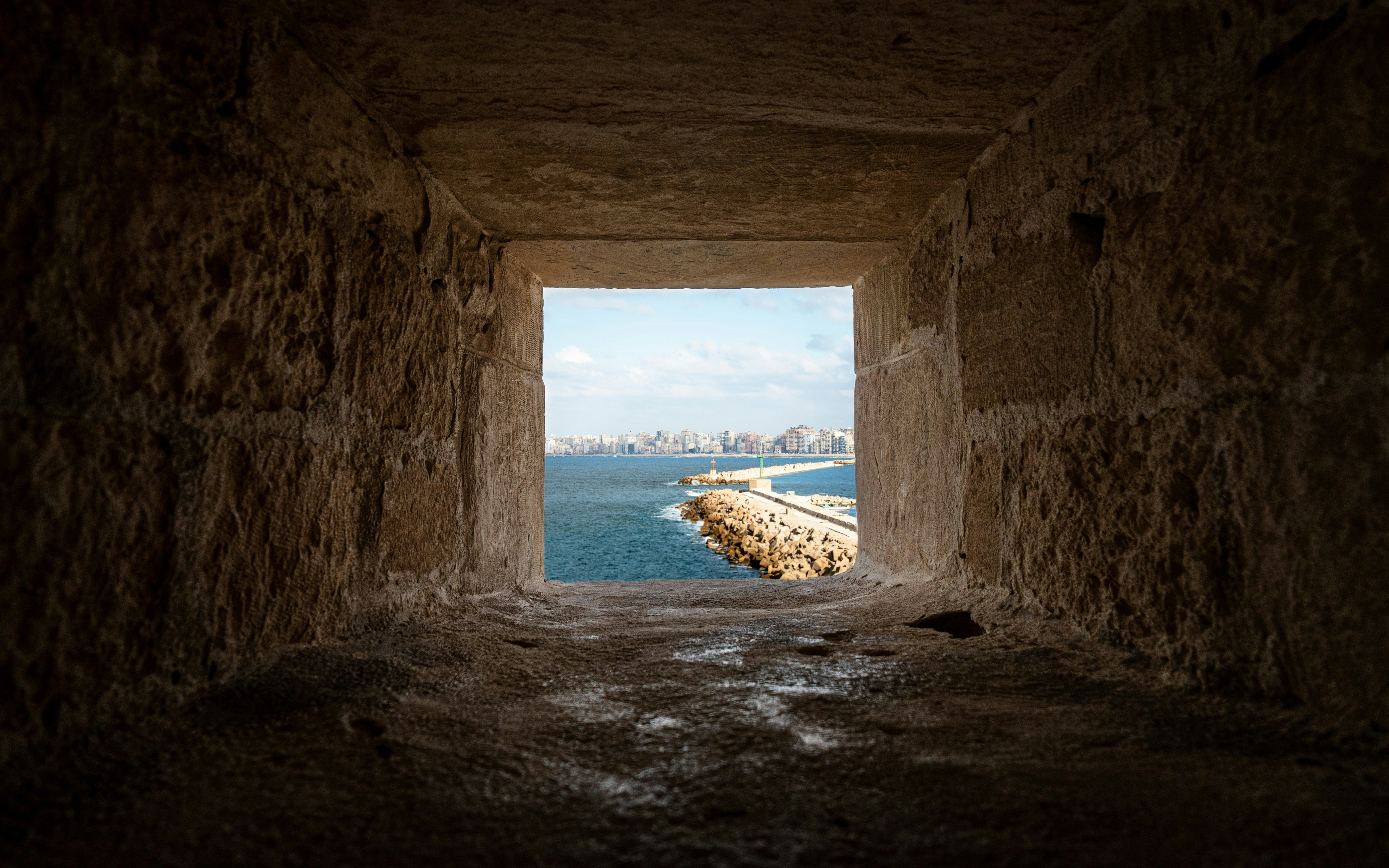View through a stone window at the Citadel of Qaitbay overlooking the Mediterranean Sea.