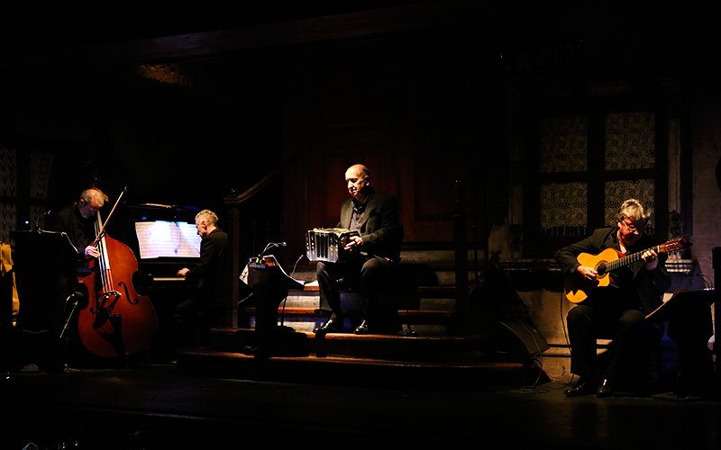 Musicians performing live at Aljibe Tango Show in Buenos Aires.