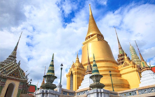 Golden stupa and ornate spires at Wat Phra Kaew, Bangkok, on a guided temple tour.