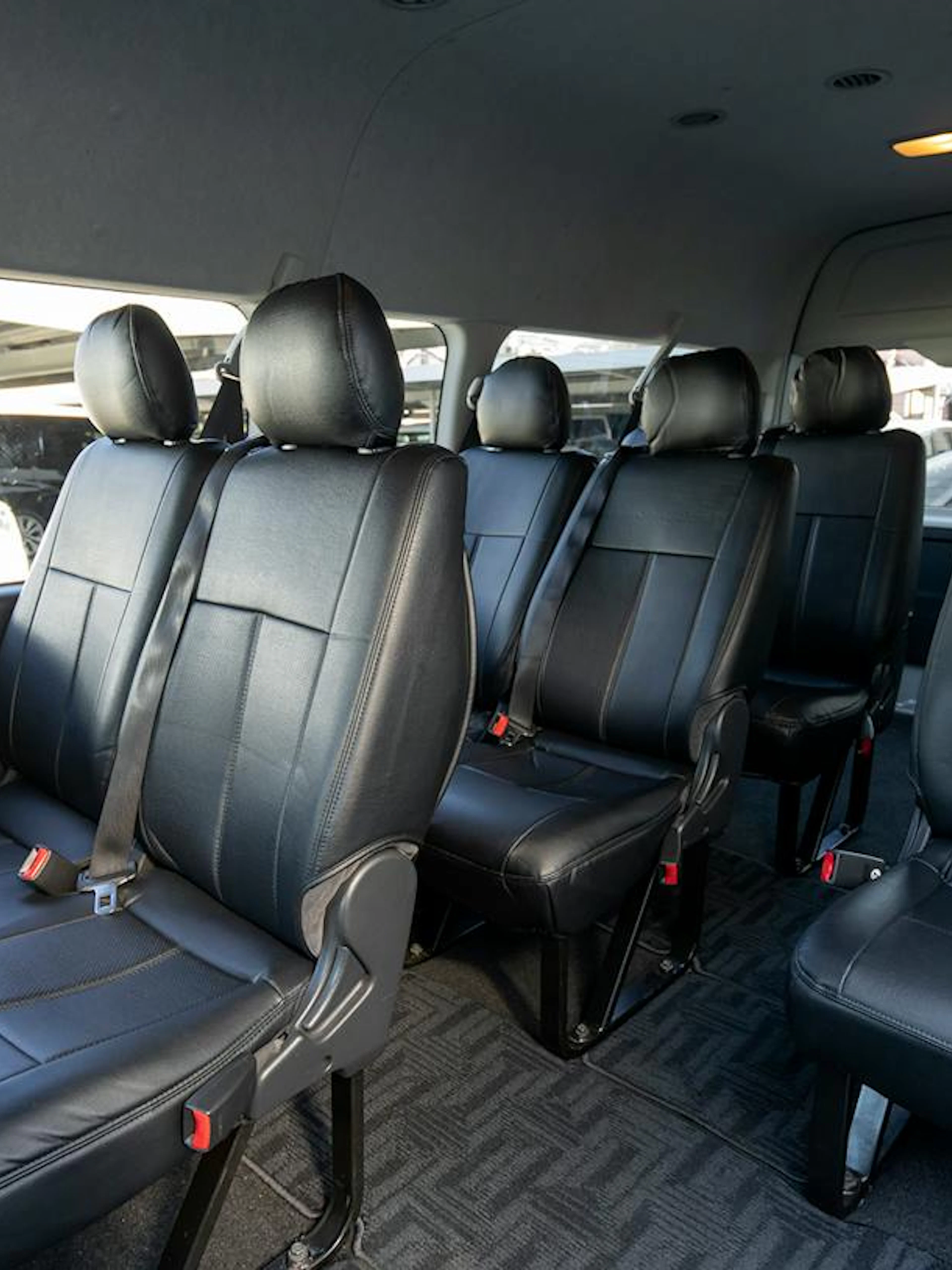 Interior of a private transfer vehicle at Narita Airport, Tokyo, with leather seating.