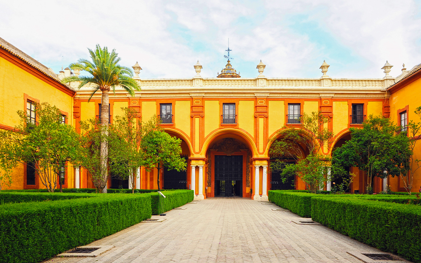 Patio del Crucero at Alcazar Seville showcasing Baroque architecture.
