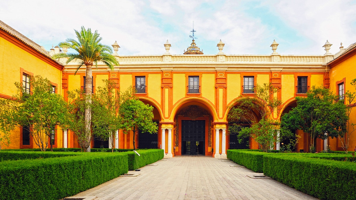 Patio del Crucero at Alcazar Seville showcasing Baroque architecture.