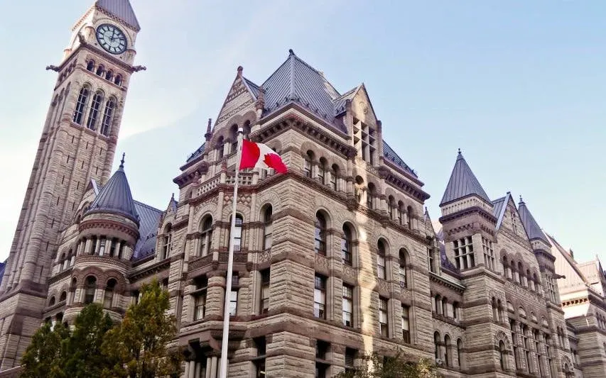 Old City Hall in Toronto with Canadian flag, part of self-guided exploration game.
