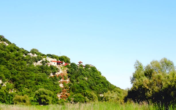 Kom Monastery on a lush hillside in Montenegro.
