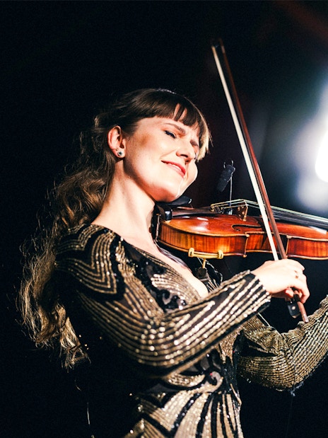 Violinist performing at Strauss concert in Prater, Vienna.