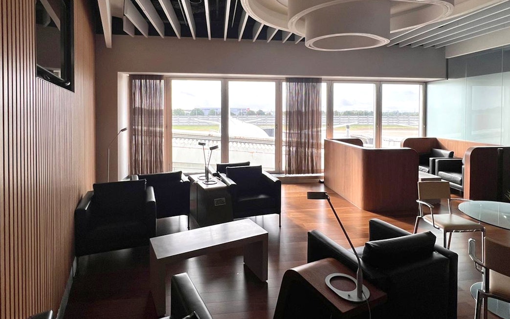 Blush Lounge seating area with runway view at Terminal 4, London Heathrow Airport.