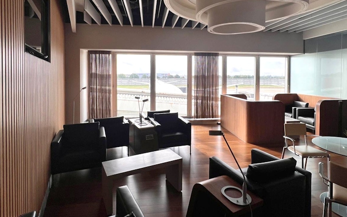 Blush Lounge seating area with runway view at Terminal 4, London Heathrow Airport.