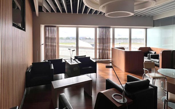 Blush Lounge seating area with runway view at Terminal 4, London Heathrow Airport.
