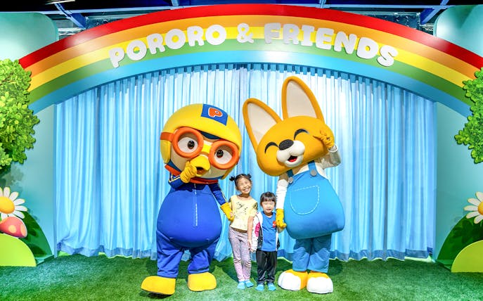 Children posing with Pororo and Eddy characters at Pororo Park Singapore.