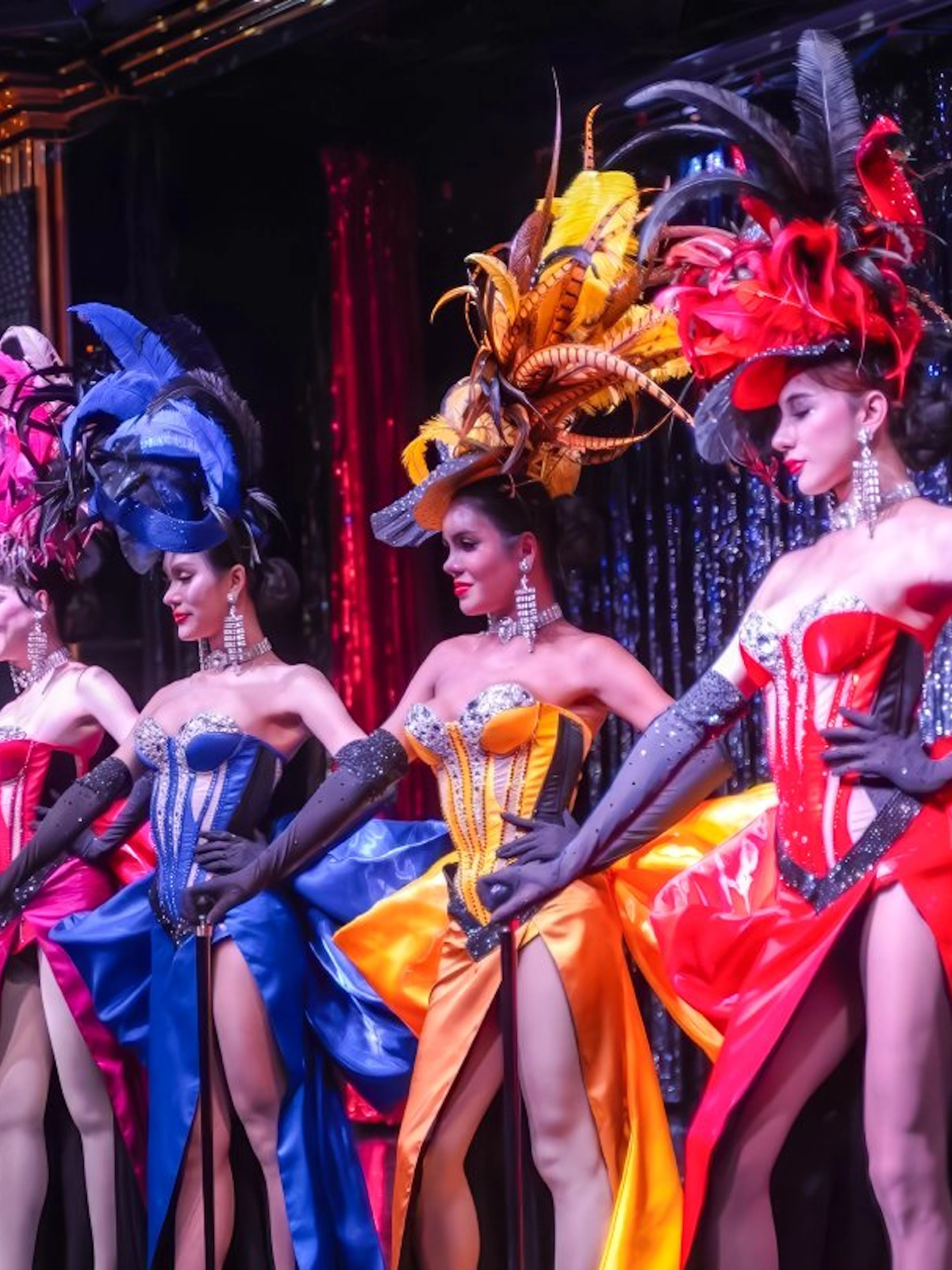 Performers in colorful costumes at Calypso Cabaret show, Bangkok.